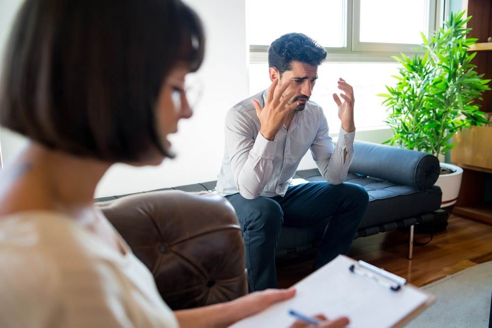 Depression therapist providing counselling to client, client expressing the emotions